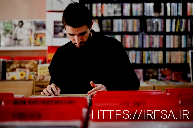 Free photo medium shot of young man looking for vinyls in store